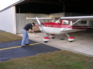 Dad putting the plane away in the hangar after flying